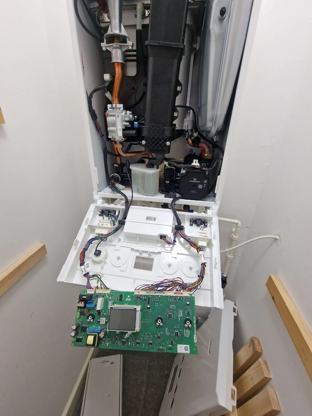 Faulty PCB main circuit board removed from a boiler for replacement