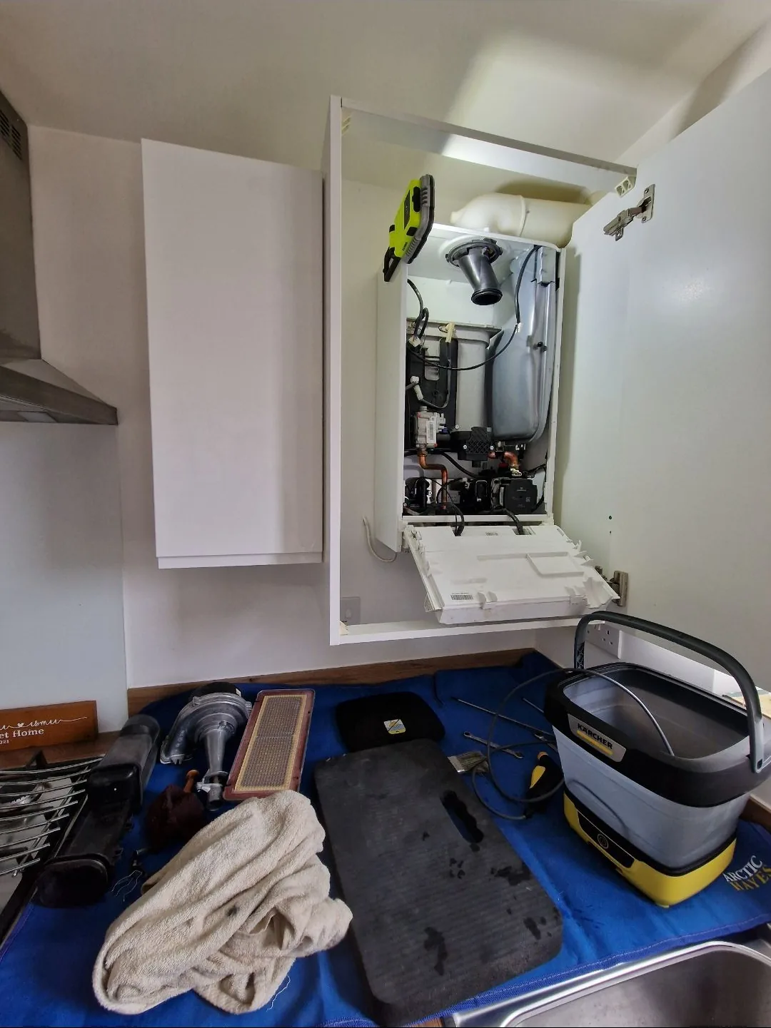 Full strip-down boiler service with components laid out on the worktop for a proper deep clean